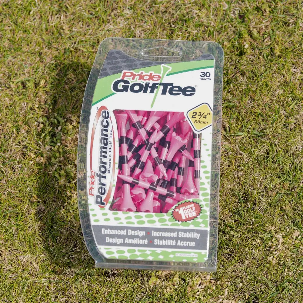 Citrus pink striped pride performance golf tee packaging positioned on green turf.