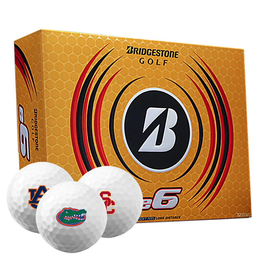 Box of Bridgestone e6 golf balls with three golf balls imprinted with different college logos on a white background