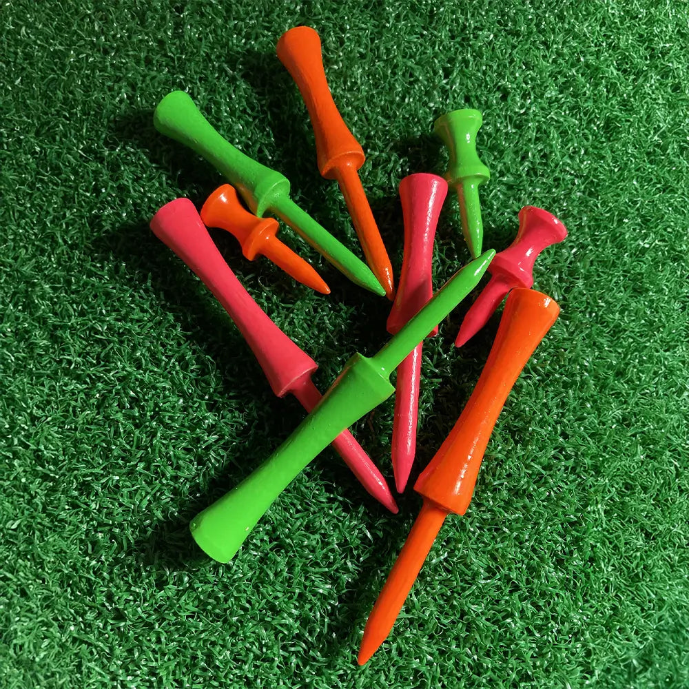 Three different sizes of the citrus 2 3/4" Pride Golf Tee Step Tees on green turf.