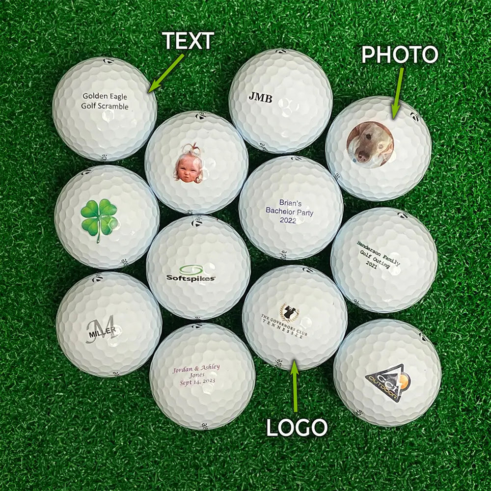 Collection of Taylormade golf balls with text, photo, and logo imprints on a grass surface