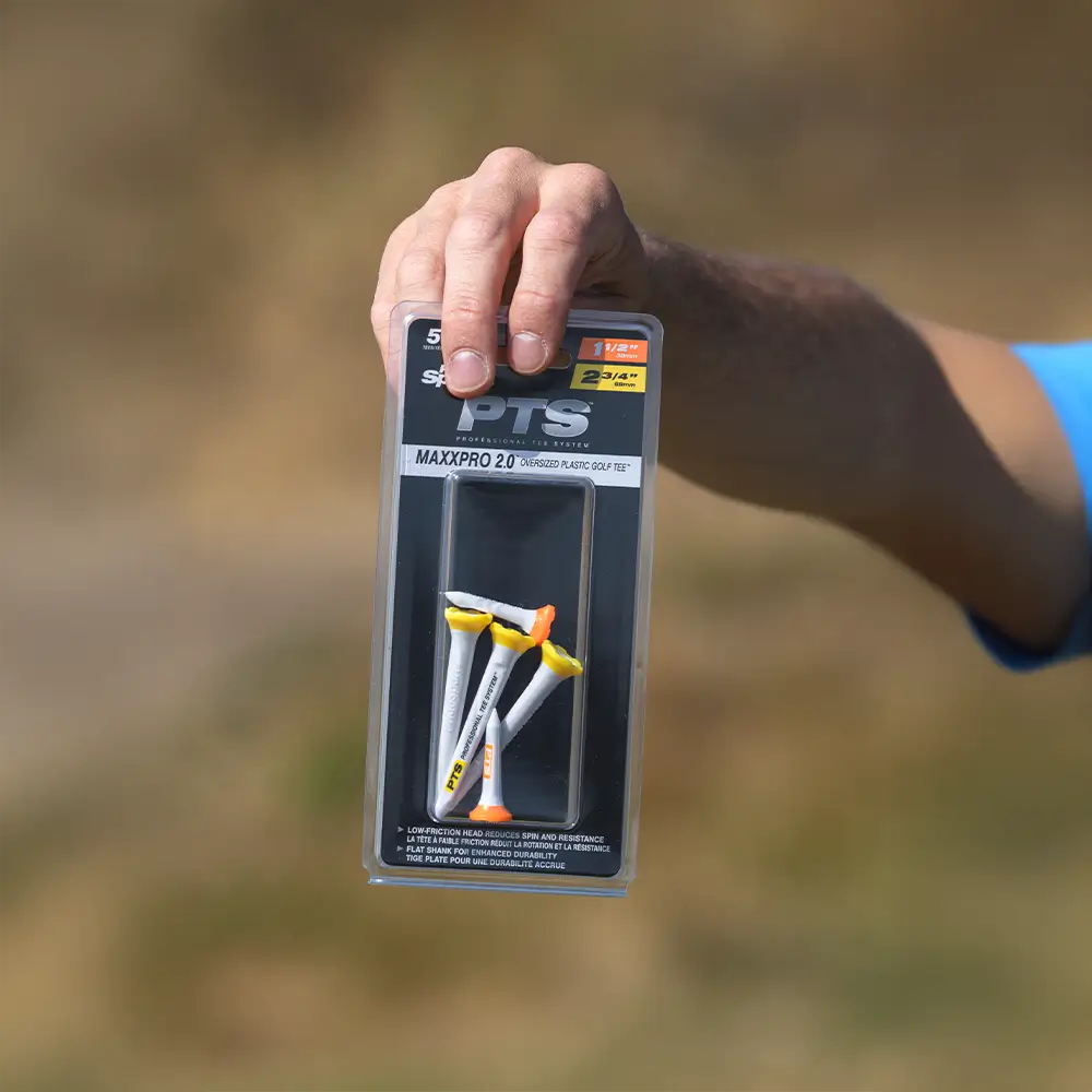 Person holding the PTS® 1-1/2 & 2-3/4 MaxxPro 2.0 Tees packaging.