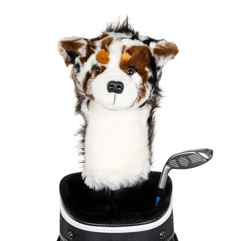 A plush dog headcover peeks out from a golf bag, featuring a fluffy design with brown and white markings.