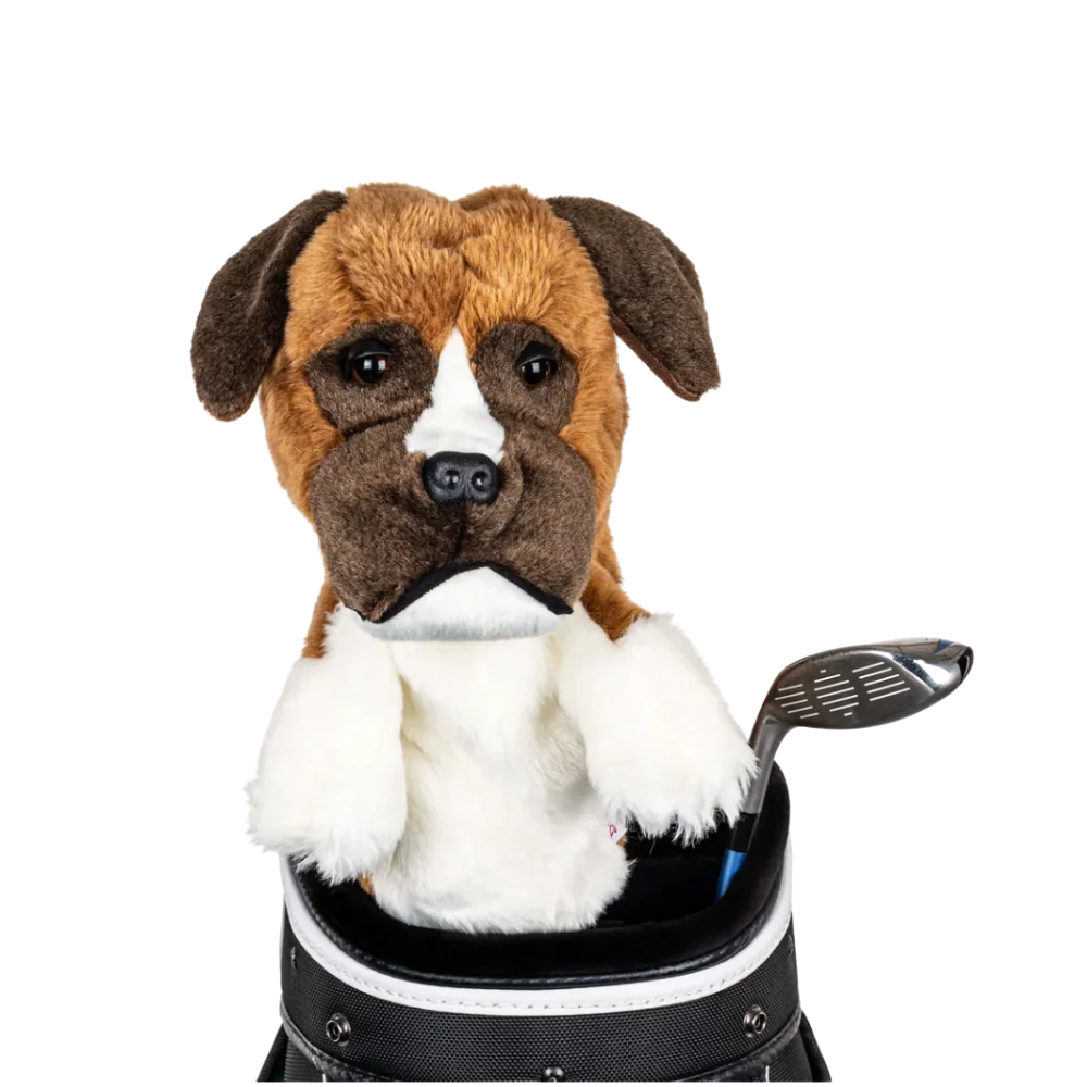 A plush dog headcover peeks out from a golf bag, featuring a fluffy design with brown and white markings.