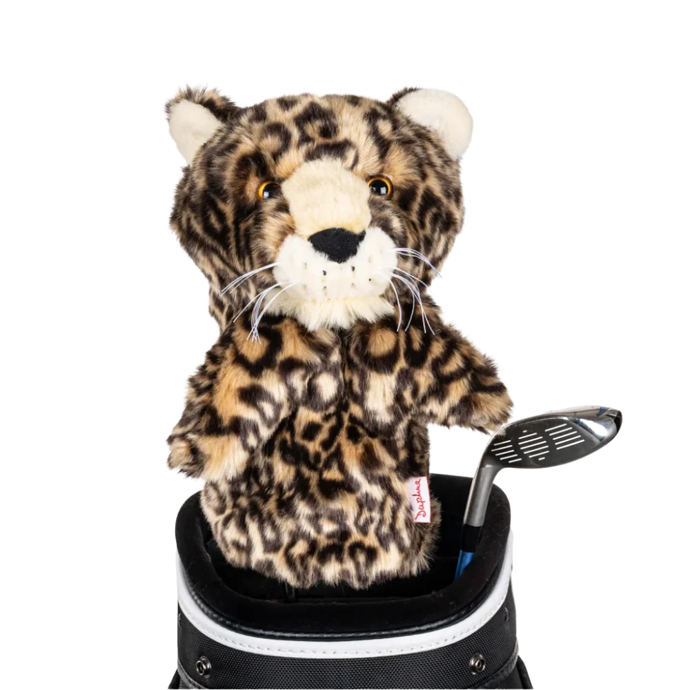 A leopard-shaped golf club head cover sitting in a golf bag, with a club peeking out.