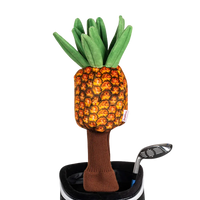A pineapple-shaped golf club head cover sitting in a golf bag, with a club peeking out.