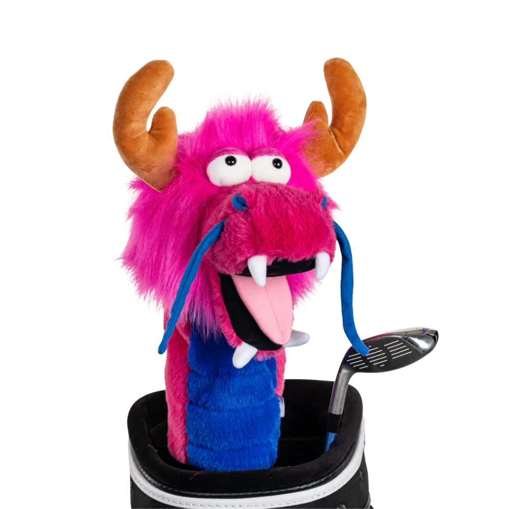 A pink dragon-shaped golf club head cover sitting in a golf bag, with a club peeking out.
