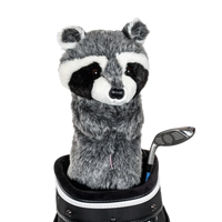 A raccoon-shaped golf club head cover sitting in a golf bag, with a club peeking out.