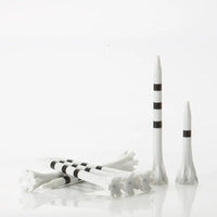 White golf tees with black stripes on a white background