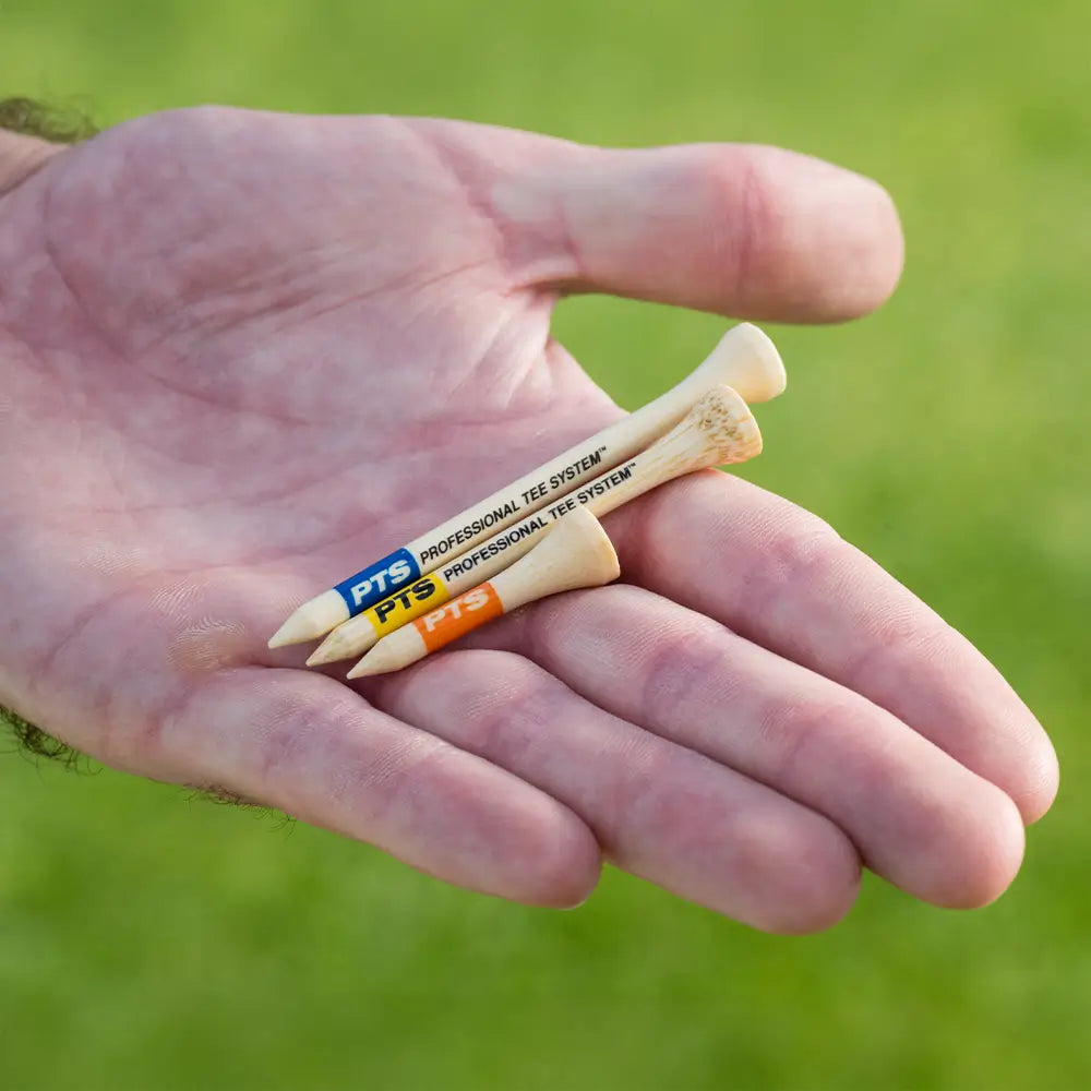 A man holding the three different PTS bamboo tee lengths. 
