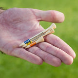 A man holding the three different PTS bamboo tee lengths. 