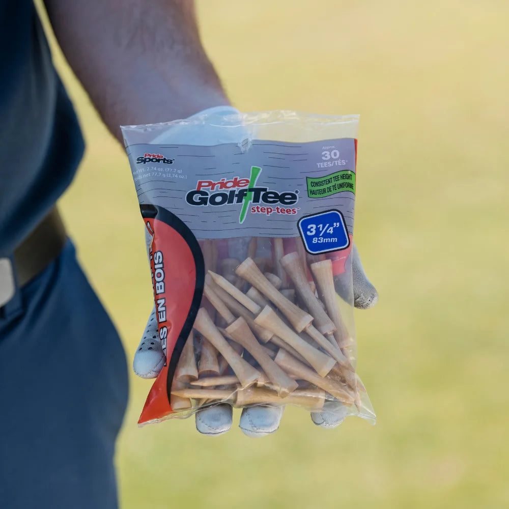 Hand holding a package of Pride Golf Tee with a blurred background