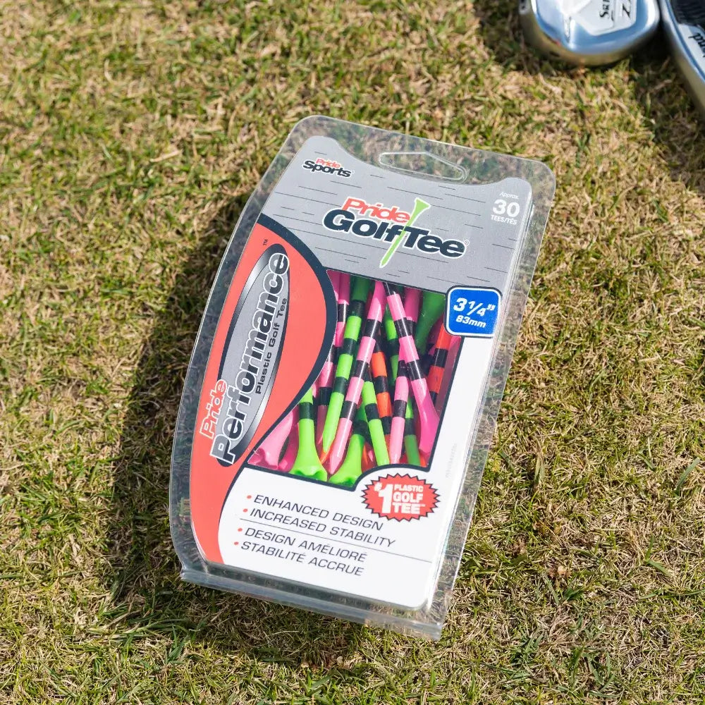 Pride Performance neon mix striped golf tee packaging on green turf. 