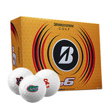 Box of Bridgestone e6 golf balls with three golf balls imprinted with different college logos on a white background