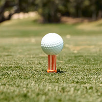 A golf ball positioned an orange oversize BrushT. 