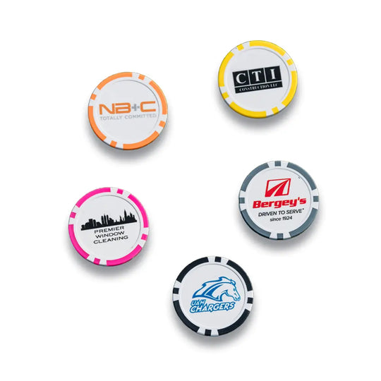 Five custom ball markers with different imprinted logos on them. 