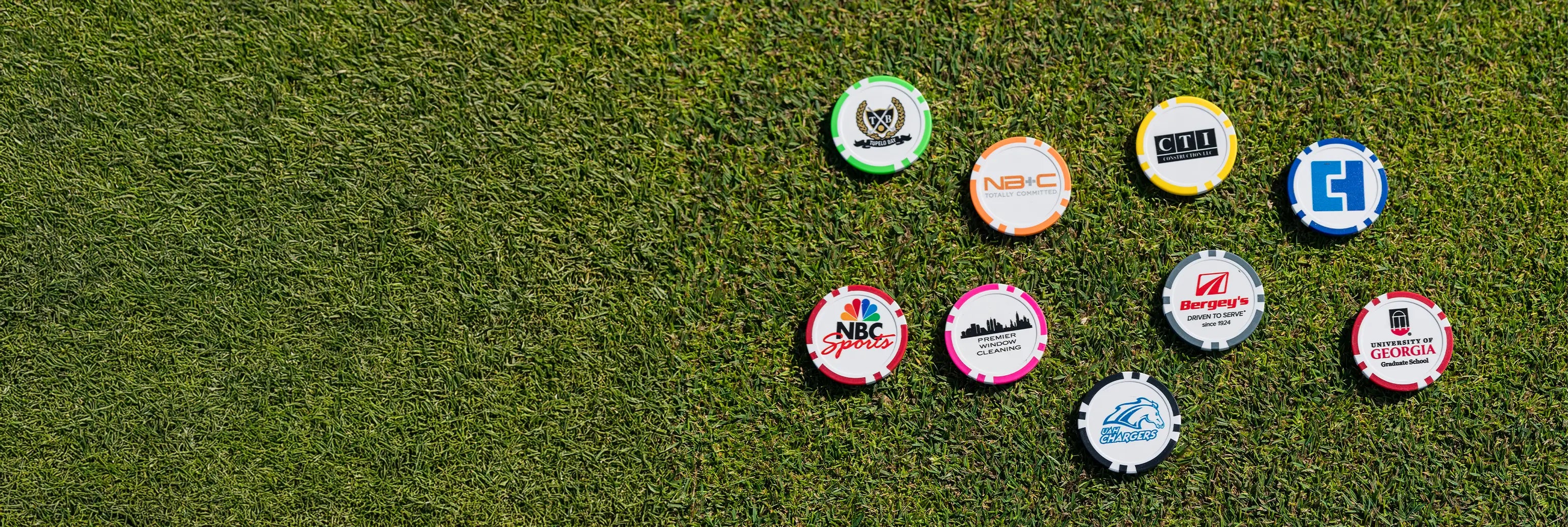 Nine multi-colored custom ball markers with different custom logos and imprints on each marker. 