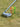 Three multi neon colored pride performance tees positioned next to a golf club on the ground. 