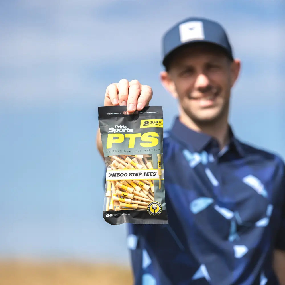 A golfer holding the 2-3/4" PTS bamboo tee packing.