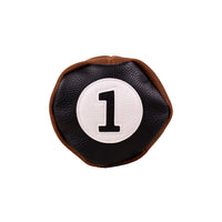 Top view of the Honors Collection barrel driver headcover's black leather cap with white number 1 patch.