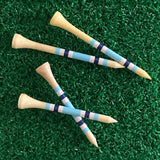 Golf tees with blue and white stripes on a green grass background