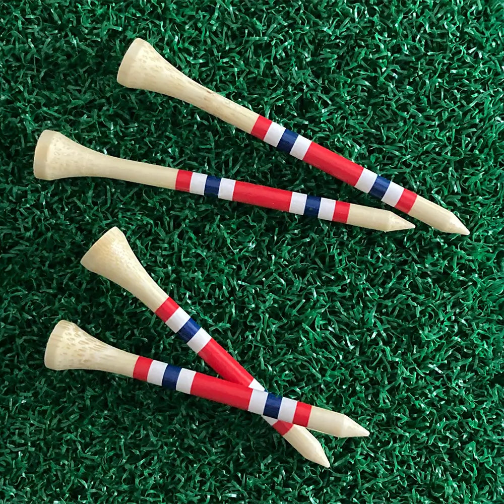 Two sizes of the Nova Bamboo Golf Tees™  on green turf. 