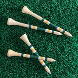 Two sizes of the Nova Bamboo Golf Tees™  on green turf. 