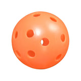 Orange practice golf ball with holes on a white background