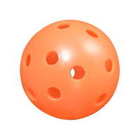 Orange practice golf ball with holes on a white background