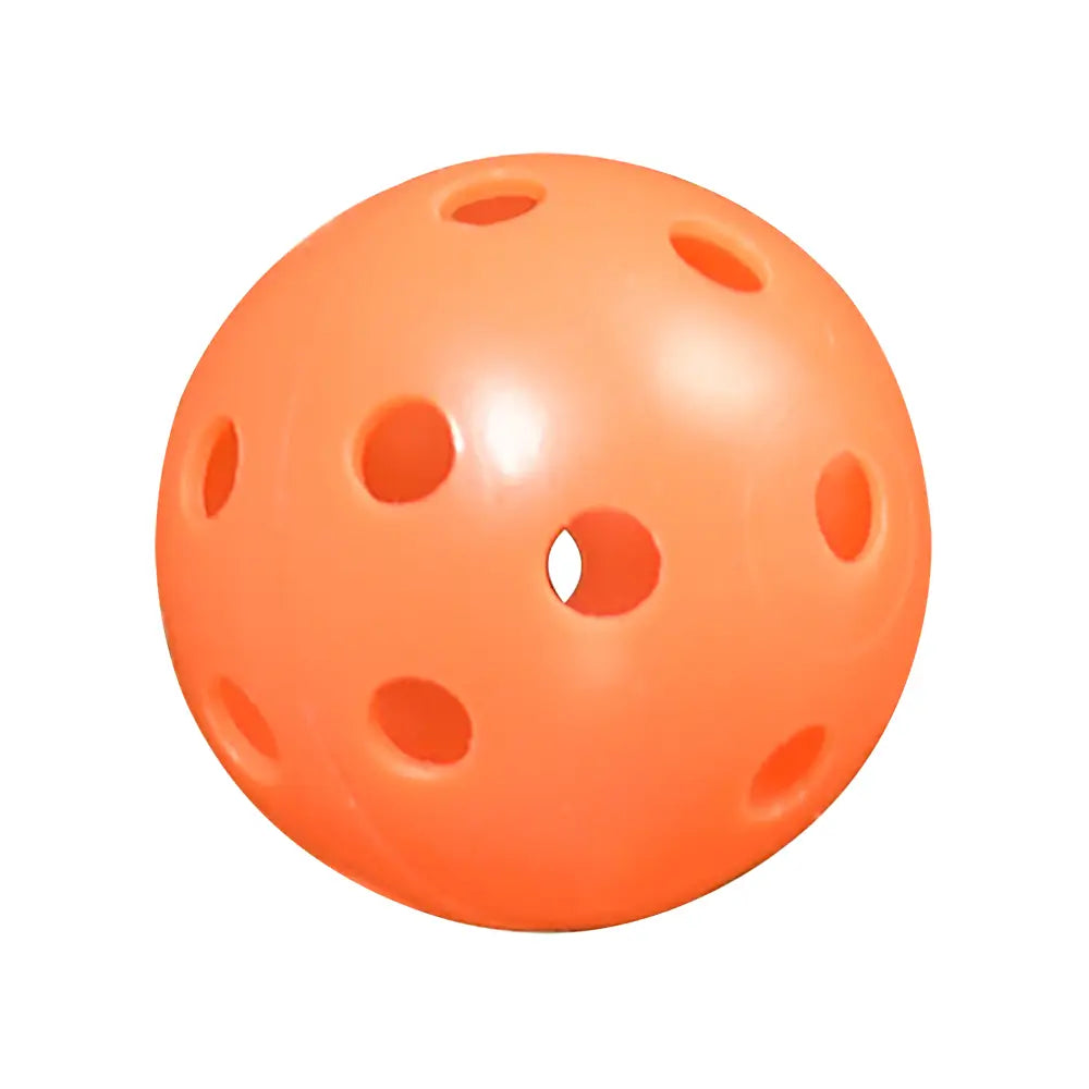 Orange practice golf ball with holes on a white background