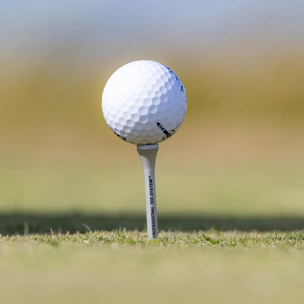 A golf ball sitting on the PTS® Titanium Strength™ Wood Golf Tee.