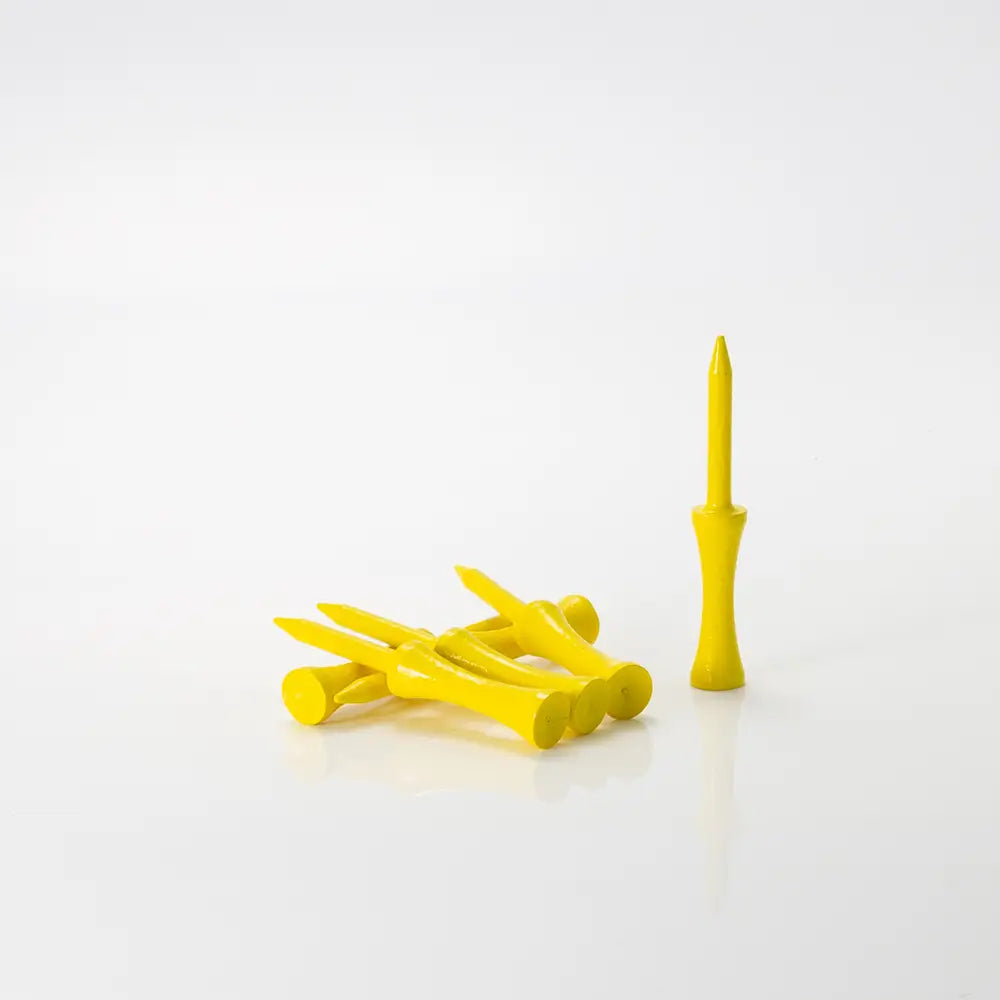 Yellow golf tees on a white background