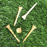 Five natual 3 1/4" Pride Golf Tee® Packs on green turf. 