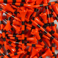 Close-up of a large pile of orange and black striped golf tees.
