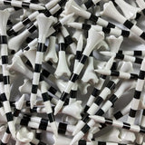 Close-up of black and white striped golf tees.
