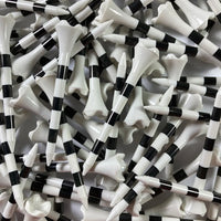 Close-up of black and white striped golf tees.