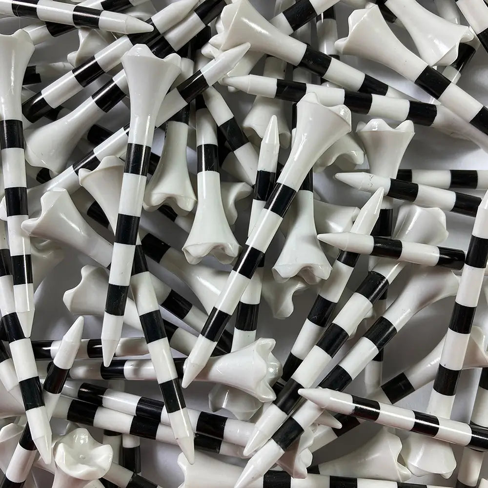 Close-up of black and white striped golf tees.