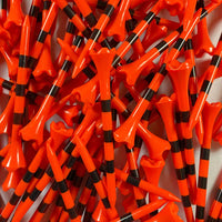 Pile of orange and black striped golf tees on a white background