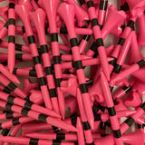 Close-up of pink and black striped golf tees.