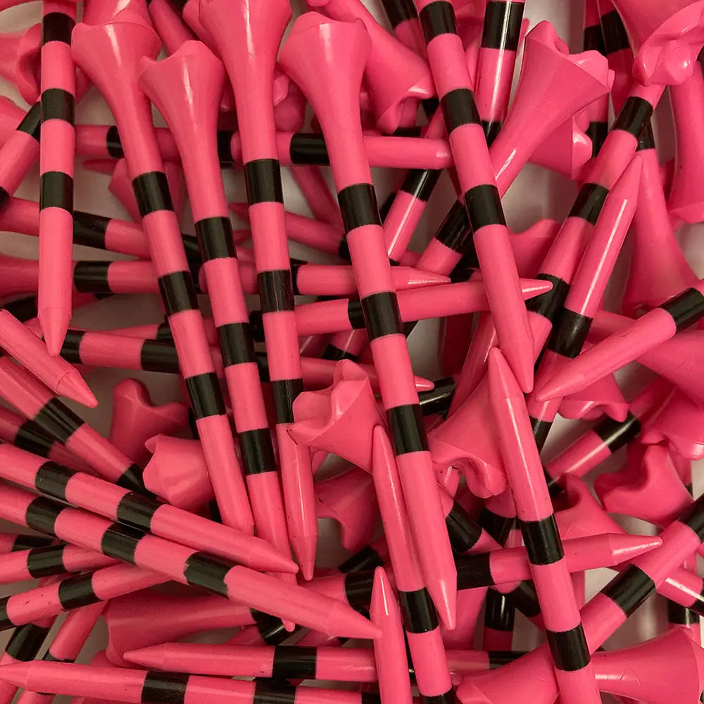 Close-up of pink and black striped golf tees.