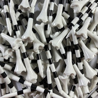 Close-up of a pile of black and white striped golf tees.