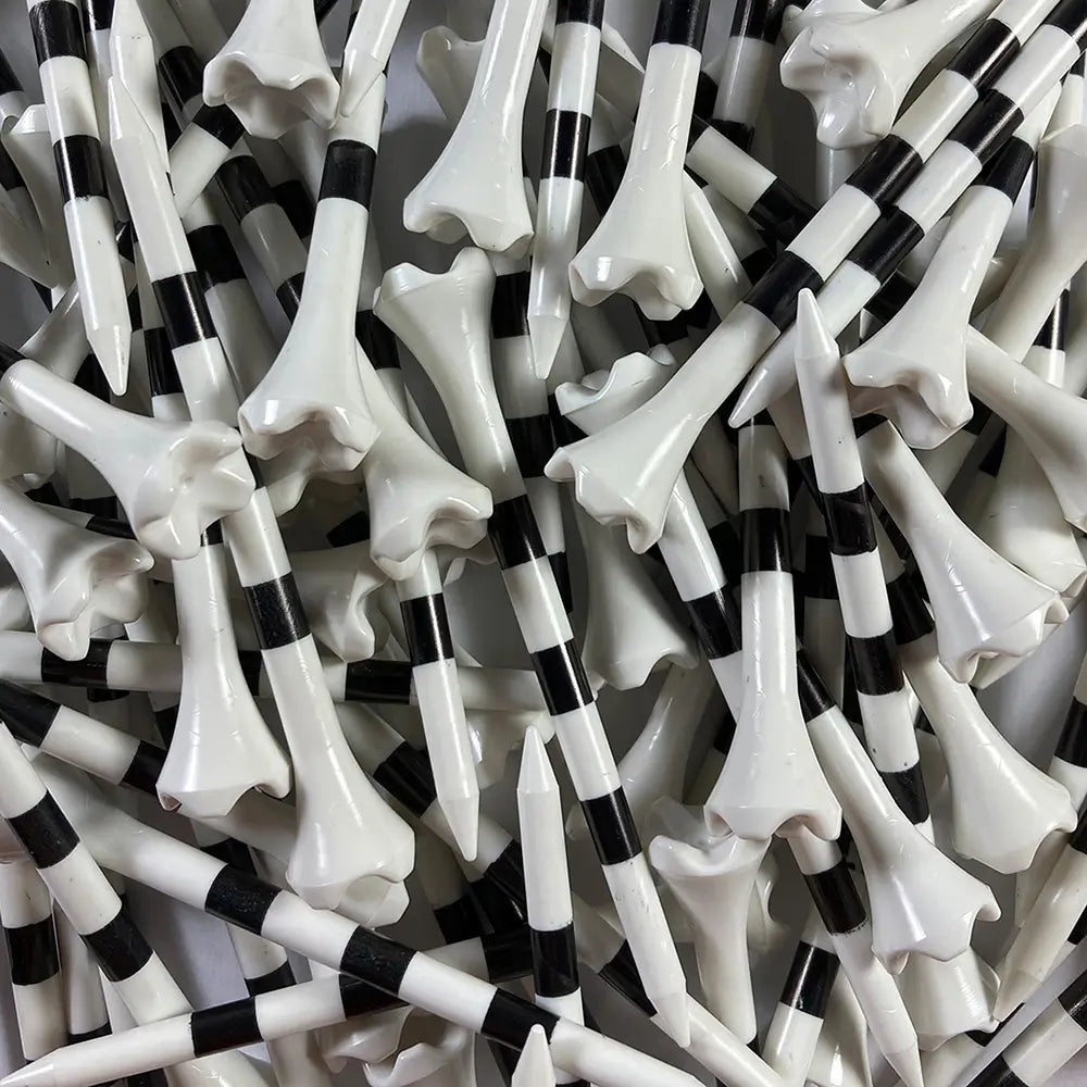 Close-up of a pile of black and white striped golf tees.