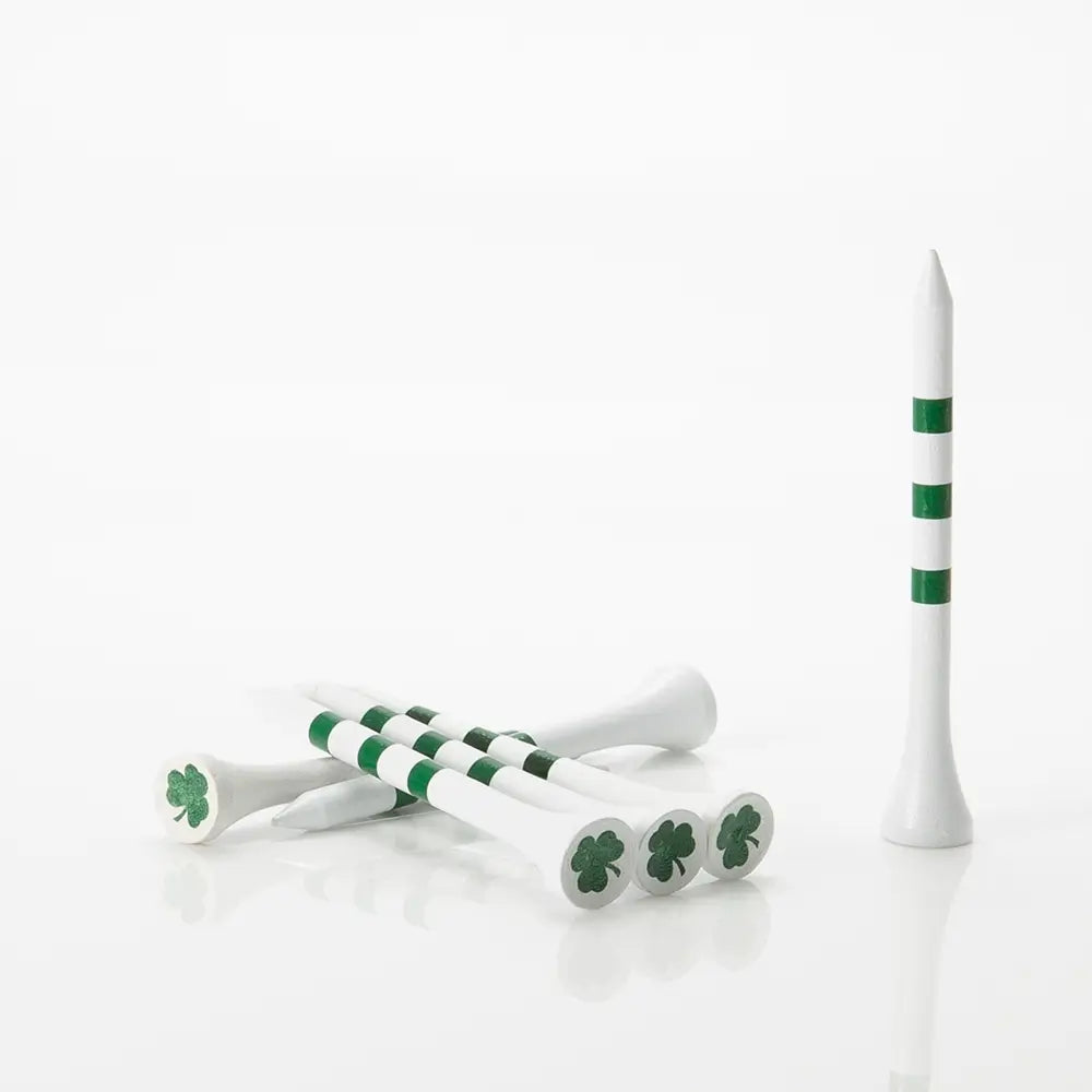 Green and white golf tees with shamrock design on a white background