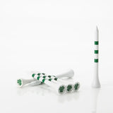 Green and white golf tees with shamrock design on a white background