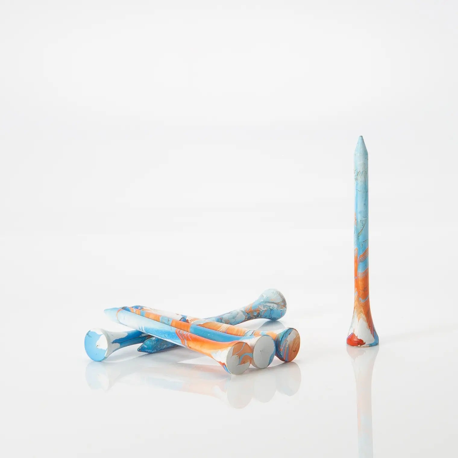 Six Blue/Orange tees laying by one another. 