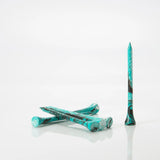 Six Turquoise/Black tees laying by one another. 