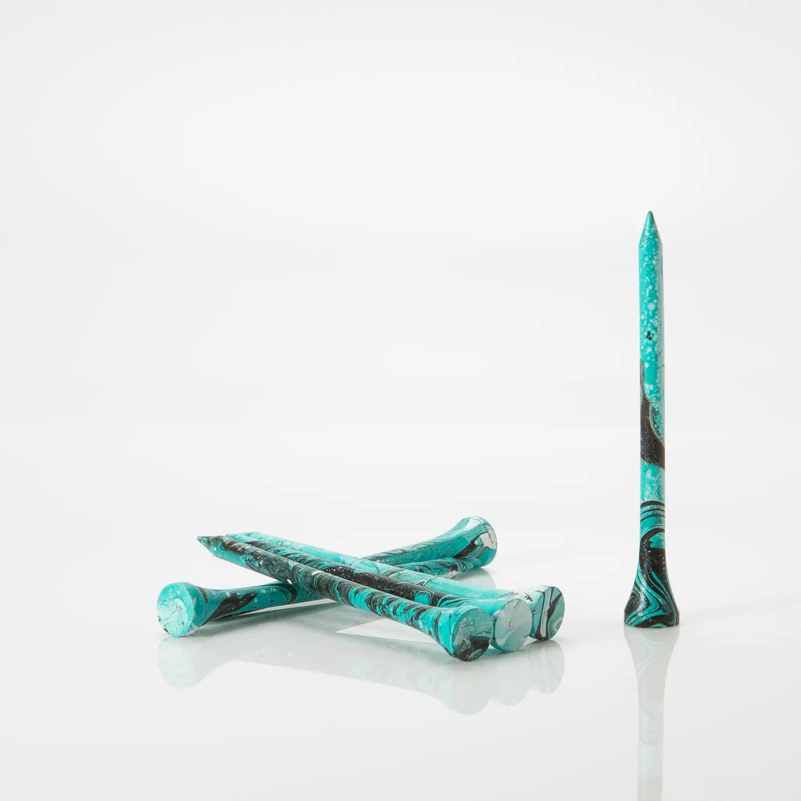 Six Turquoise/Black tees laying by one another. 