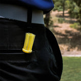 A yellow Brusht golf tee in a persons back pocket. 