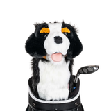 A plush dog headcover peeks out from a golf bag, featuring a fluffy design with black and white markings.