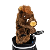 A boar-shaped golf club head cover sitting in a golf bag, with a club peeking out.