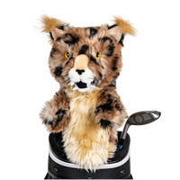 A bobcat-shaped golf club head cover sitting in a golf bag, with a club peeking out.